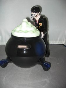 black cauldron cookie jar with Harry Potter standing behind it