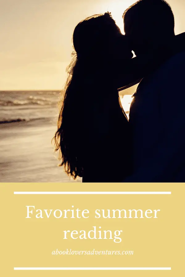 couple on beach at sunset - what genre do you read during the summer?