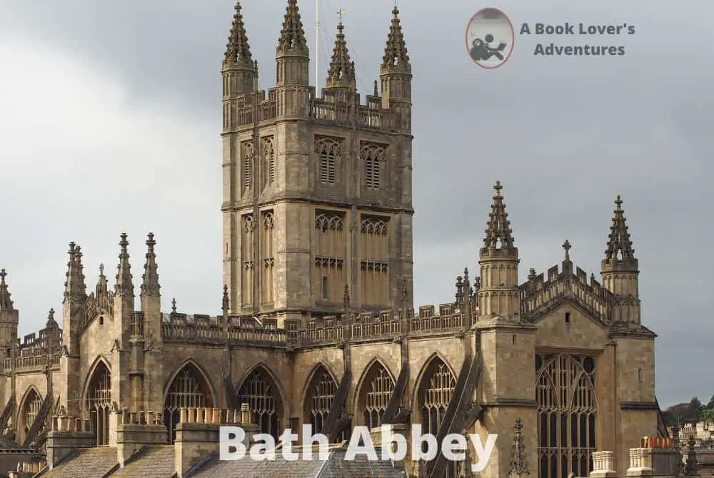 Exterior of the Bath Abbey, a cross shaped stone building with a center spire. Very gothic looking. Great spot to visit on your Day Trip to Bath