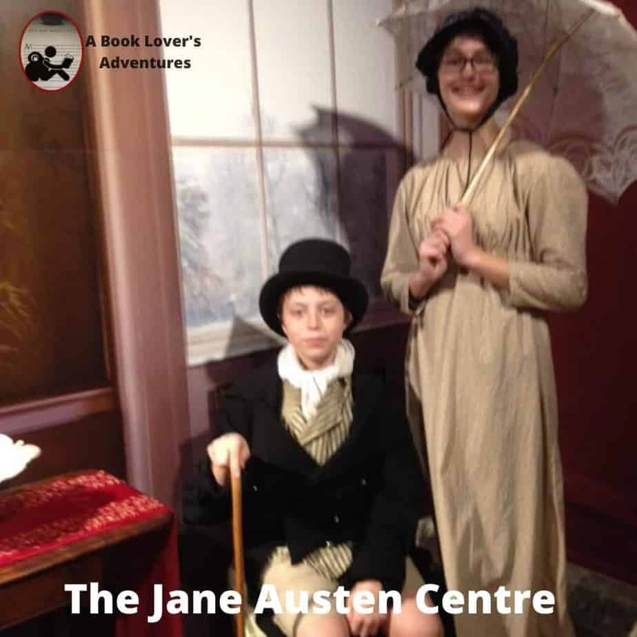 Girl with plain dress and parasol and boy with top hat, vest, short jacket and cane. Dressed up at the Jane Austen Centre during our Day Trip to Bath